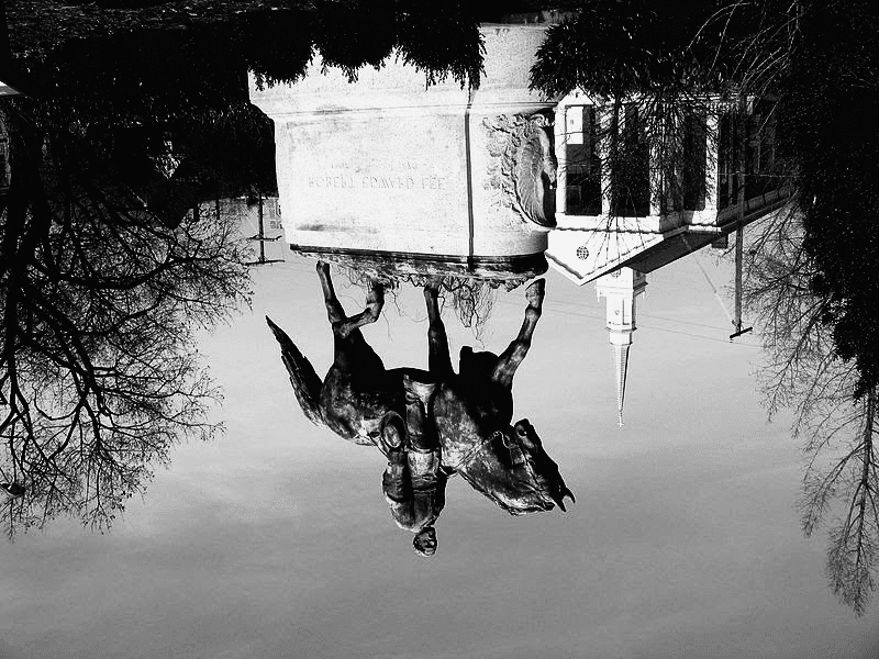 Toppled head of monument to image